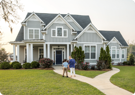house with mom and son standing outside